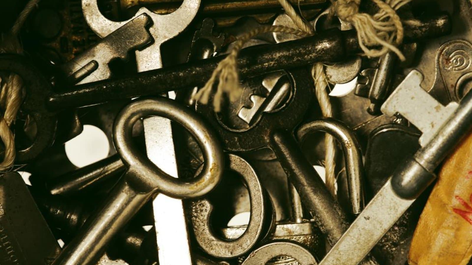 A pile of old keys and padlocks